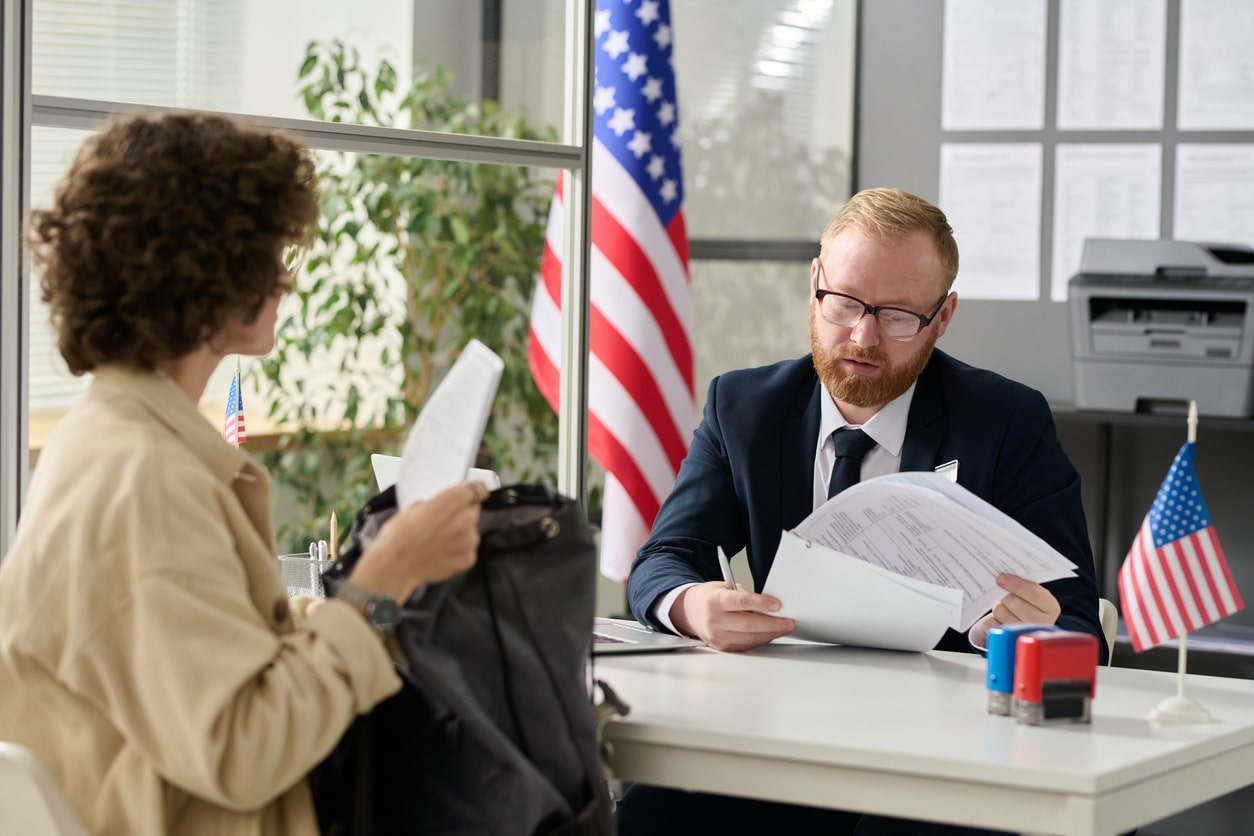 Young woman applying for visa in US immigration office, us immigration news green card backlog