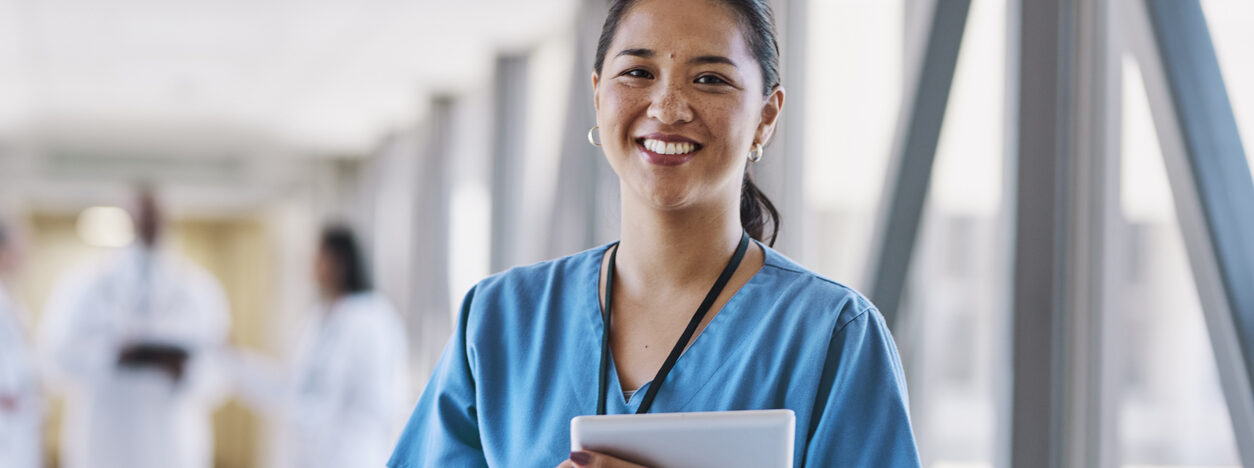 EB-3 for international nurse immigration smiling nurse in hospital corridor