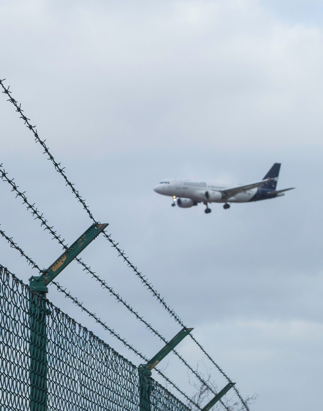 Plan flying over U.S. border fence to represent Common Grounds for Deportation